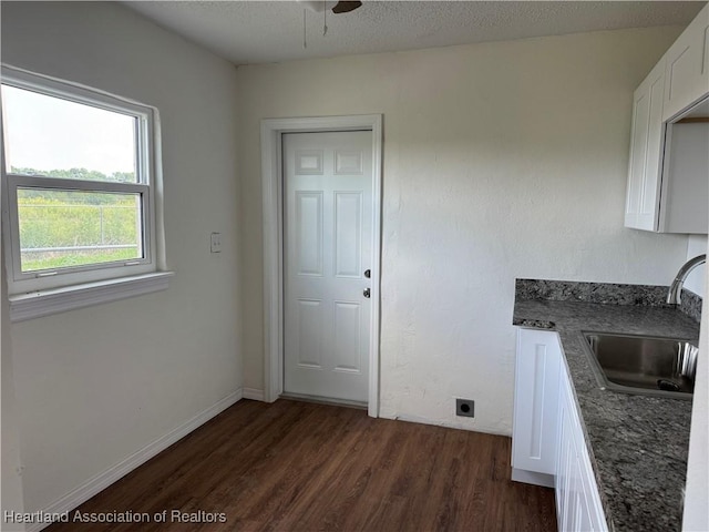 4504 High Ave, Sebring, FL 33870 - kitchen with a sink, dark wood finished floors, white cabinetry, dark stone countertops, and a ceiling fan