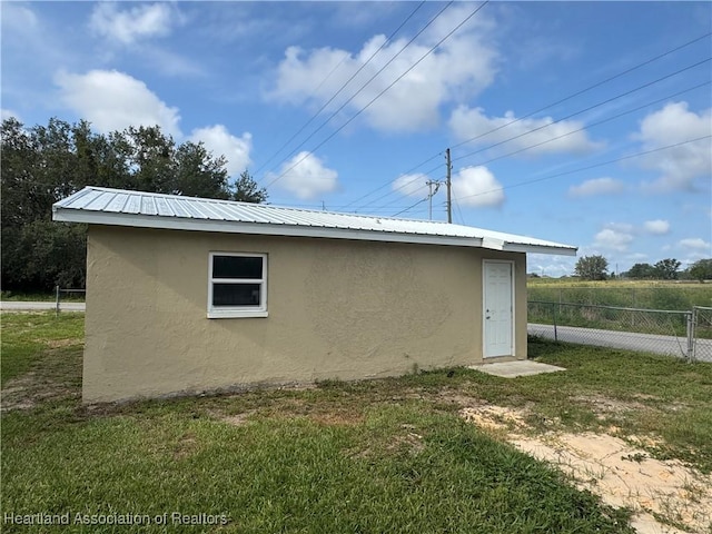 4504 High Ave, Sebring, FL 33870 - view of side of property with stucco siding and metal roof