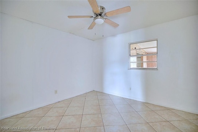 spare room with light tile patterned flooring and ceiling fan