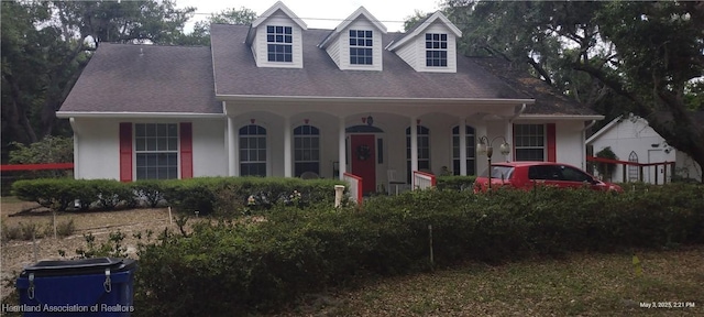 2212 Wolf Rd, Sebring, FL 33875 - cape cod-style house featuring stucco siding and a shingled roof