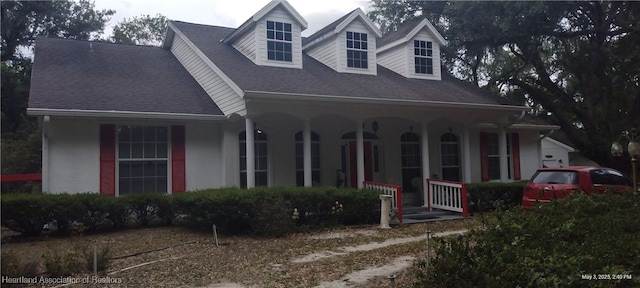 2212 Wolf Rd, Sebring, FL 33875 - view of front facade with covered porch, stucco siding, and roof with shingles