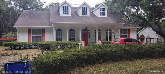 2212 Wolf Rd, Sebring, FL 33875 - cape cod home featuring stucco siding and roof with shingles