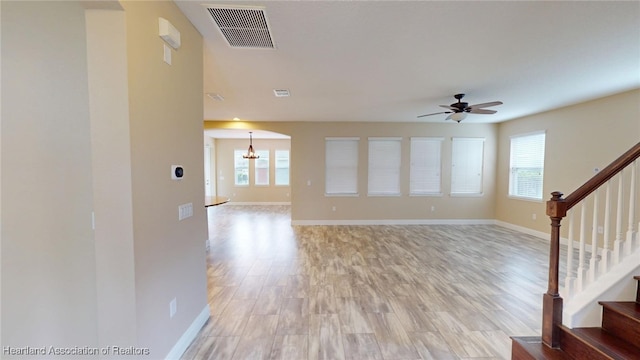 5406 Fishhawk Dr, Lithia, FL 33547 - unfurnished living room featuring stairway, baseboards, visible vents, and light wood finished floors