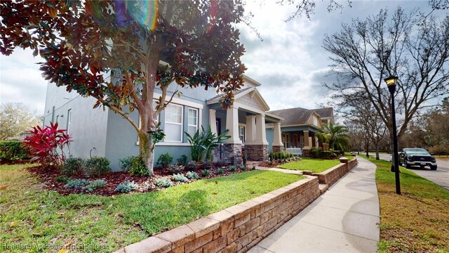 5406 Fishhawk Dr, Lithia, FL 33547 - view of side of property with stone siding, a yard, and stucco siding