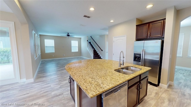5406 Fishhawk Dr, Lithia, FL 33547 - kitchen featuring stainless steel appliances, a sink, visible vents, open floor plan, and a center island with sink