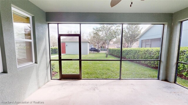 5406 Fishhawk Dr, Lithia, FL 33547 - unfurnished sunroom featuring a ceiling fan and a healthy amount of sunlight