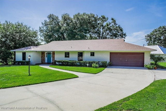 ranch-style house featuring a front yard and a garage