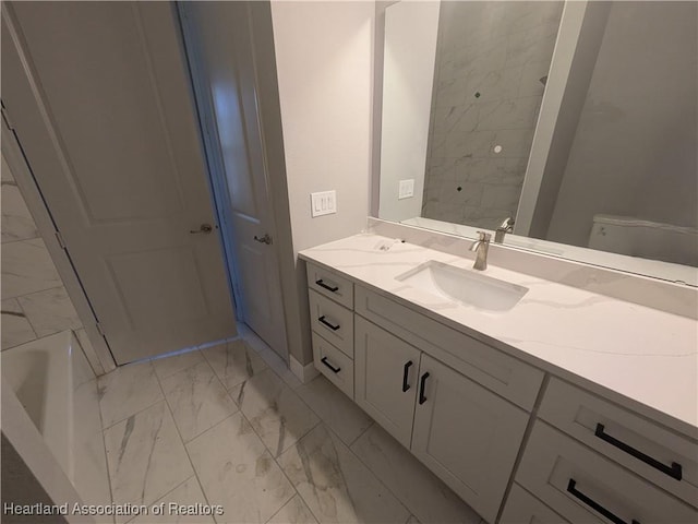 bathroom with toilet and vanity