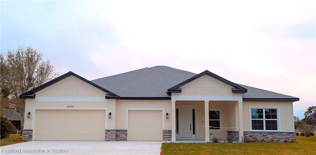 craftsman-style house featuring a garage and a lawn