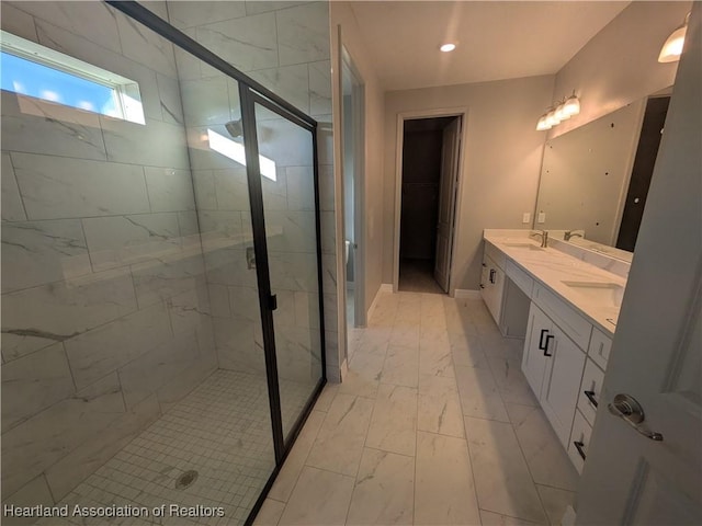 bathroom featuring vanity and a shower with door