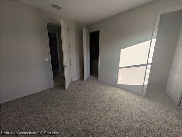 unfurnished bedroom with carpet floors and a closet