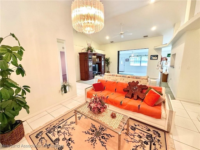 tiled living room featuring vaulted ceiling and ceiling fan with notable chandelier