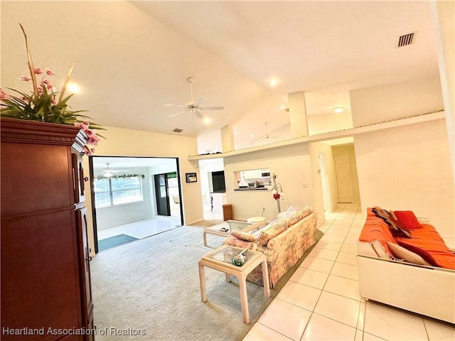 tiled living room with ceiling fan and lofted ceiling
