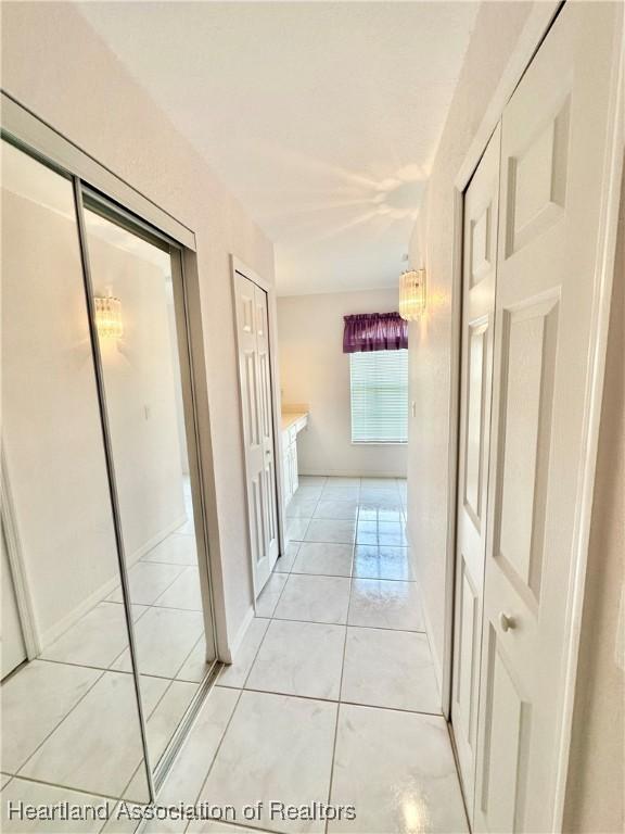 hallway with light tile patterned floors