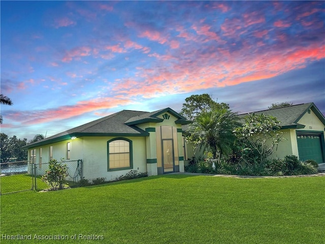 view of front facade featuring a lawn and a garage