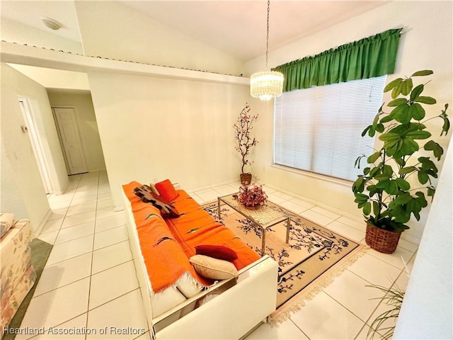 tiled living room featuring vaulted ceiling and a notable chandelier