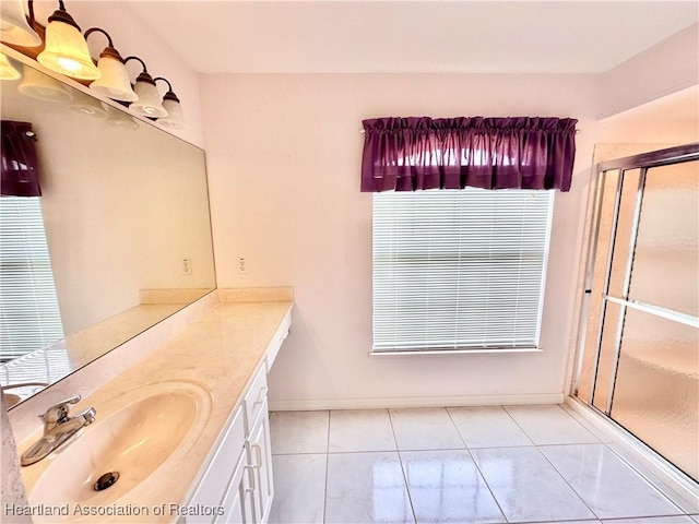 bathroom featuring tile patterned floors, vanity, and an enclosed shower