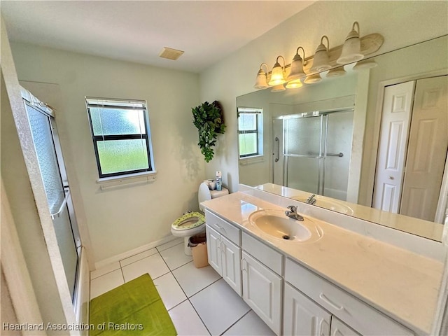 bathroom featuring tile patterned floors, a shower with door, vanity, and toilet