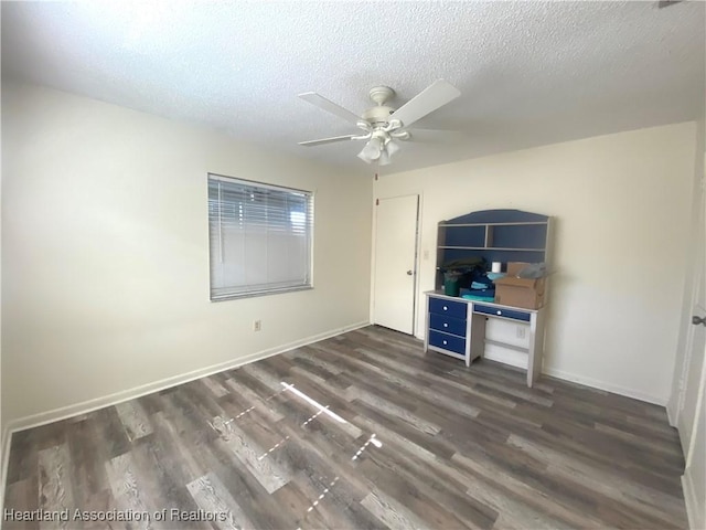 unfurnished bedroom featuring ceiling fan, dark wood-type flooring, and a textured ceiling