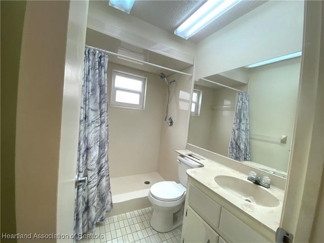 bathroom featuring tile patterned flooring, vanity, walk in shower, toilet, and a textured ceiling