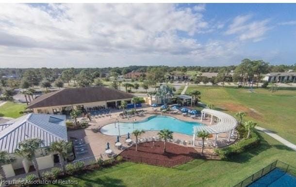 pool with a patio area and fence