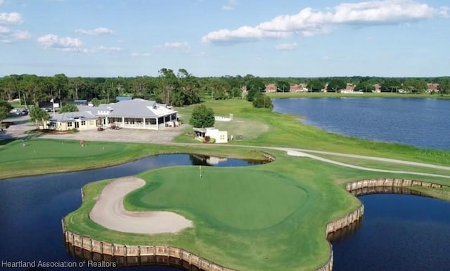 aerial view with view of golf course and a water view