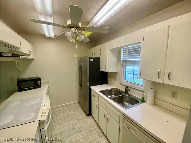 kitchen featuring white appliances, white cabinetry, and light countertops