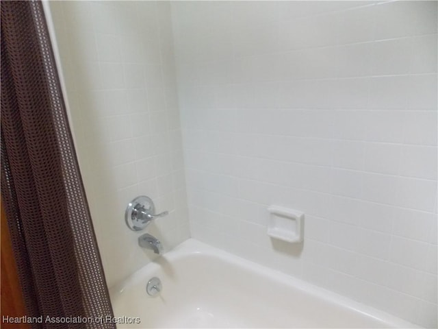 bathroom with shower / bathtub combination with curtain