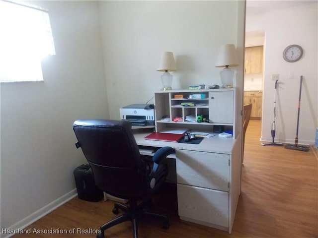 office with light wood-type flooring