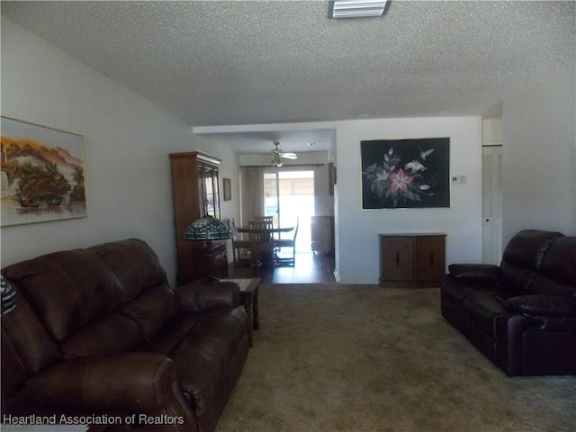 carpeted living room featuring a textured ceiling