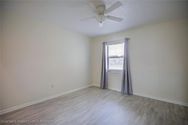 6518 Matanzas Dr, Sebring, FL 33872 - spare room featuring wood finished floors, a ceiling fan, and baseboards
