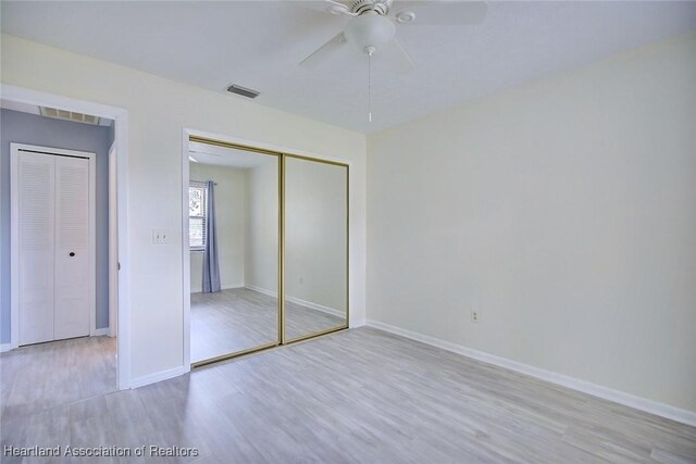 6518 Matanzas Dr, Sebring, FL 33872 - unfurnished bedroom featuring wood finished floors, a closet, baseboards, and ceiling fan