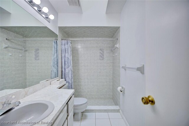 6518 Matanzas Dr, Sebring, FL 33872 - bathroom featuring tile patterned flooring, toilet, a tile shower, and vanity