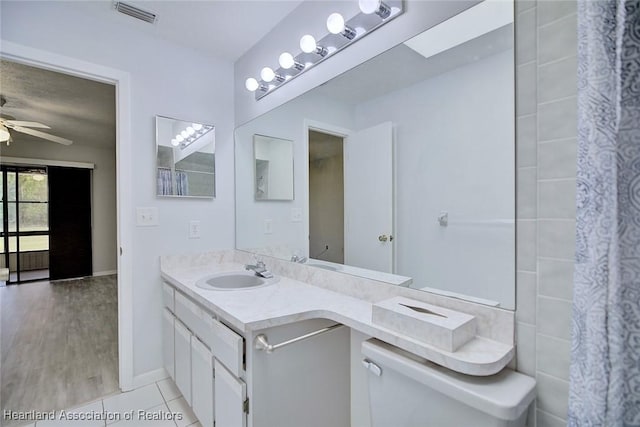 6518 Matanzas Dr, Sebring, FL 33872 - full bath featuring ceiling fan, vanity, tile patterned floors, and baseboards