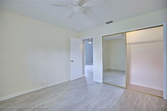 6518 Matanzas Dr, Sebring, FL 33872 - unfurnished bedroom featuring wood finished floors, baseboards, a closet, and ceiling fan