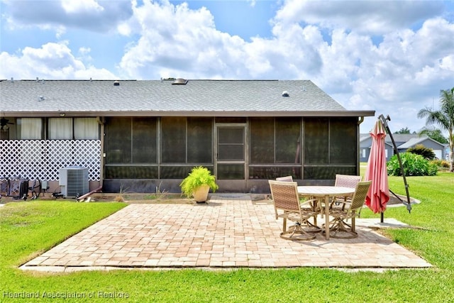 6518 Matanzas Dr, Sebring, FL 33872 - rear view of house featuring central air condition unit, a patio area, a lawn, and a sunroom