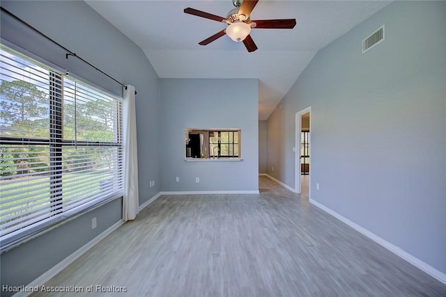 6518 Matanzas Dr, Sebring, FL 33872 - unfurnished room featuring vaulted ceiling, a ceiling fan, wood finished floors, and baseboards