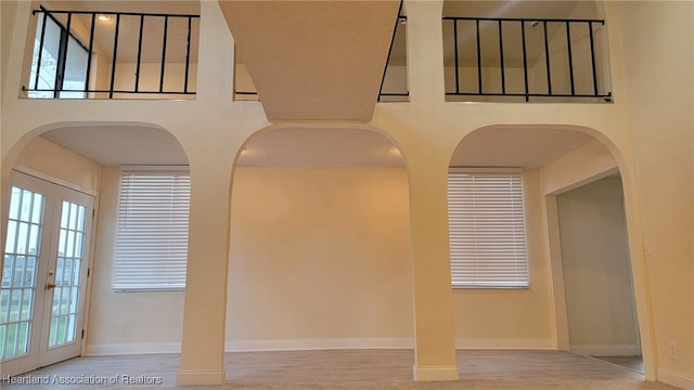 unfurnished room featuring french doors and wood-type flooring