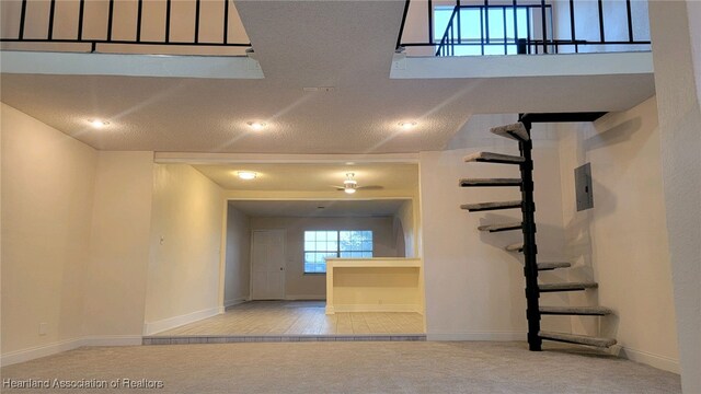 interior space with carpet flooring and a textured ceiling