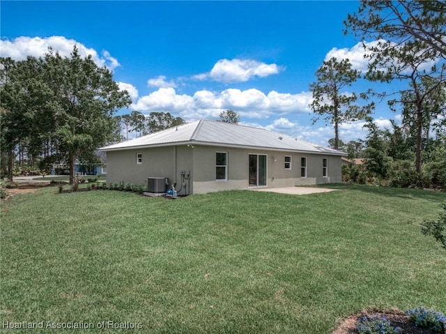 4225 Cooper Dr, Sebring, FL 33872 - rear view of property featuring stucco siding, a patio area, a yard, and a metal roof