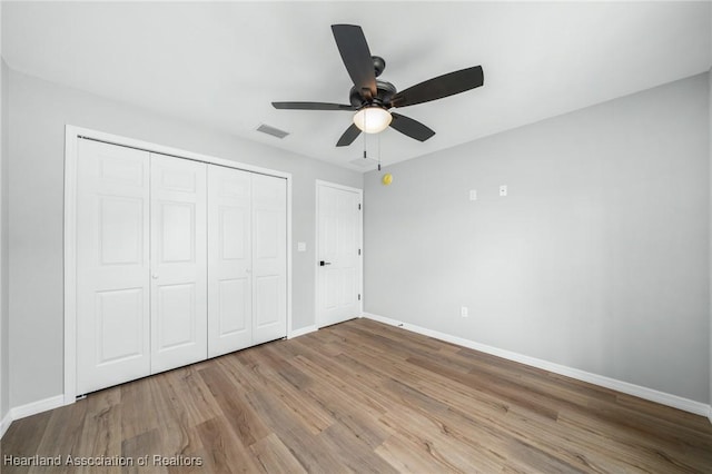 4225 Cooper Dr, Sebring, FL 33872 - unfurnished bedroom featuring wood finished floors, a closet, and ceiling fan