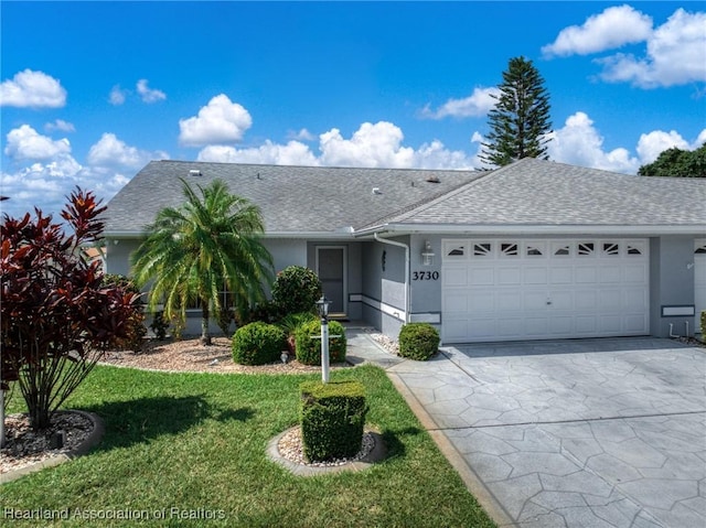 3730 Camry Ct, Sebring, FL 33872 - ranch-style house with stucco siding, a garage, a shingled roof, driveway, and a front yard