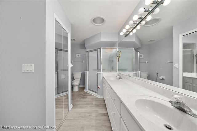 3730 Camry Ct, Sebring, FL 33872 - bathroom with double vanity, wood finished floors, and a shower stall