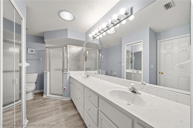 3730 Camry Ct, Sebring, FL 33872 - full bath with double vanity, wood finished floors, and a shower stall
