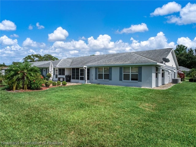 3730 Camry Ct, Sebring, FL 33872 - back of property featuring stucco siding, a lawn, a sunroom, and roof with shingles