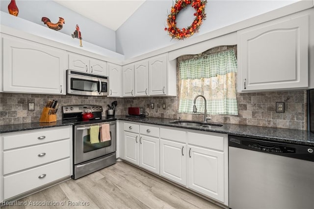 3730 Camry Ct, Sebring, FL 33872 - kitchen featuring appliances with stainless steel finishes, white cabinets, dark stone countertops, and backsplash