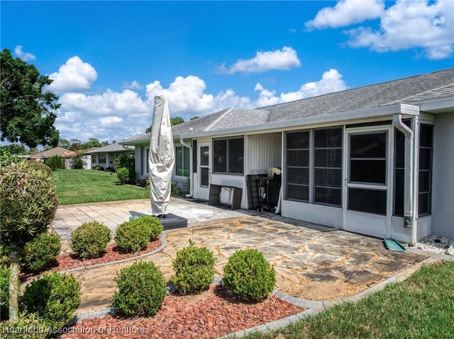 3730 Camry Ct, Sebring, FL 33872 - rear view of property with a patio area, a lawn, roof with shingles, and a chimney