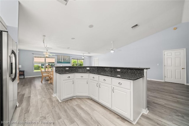 3730 Camry Ct, Sebring, FL 33872 - kitchen with stainless steel fridge, light wood-style flooring, white cabinets, a center island, and a ceiling fan