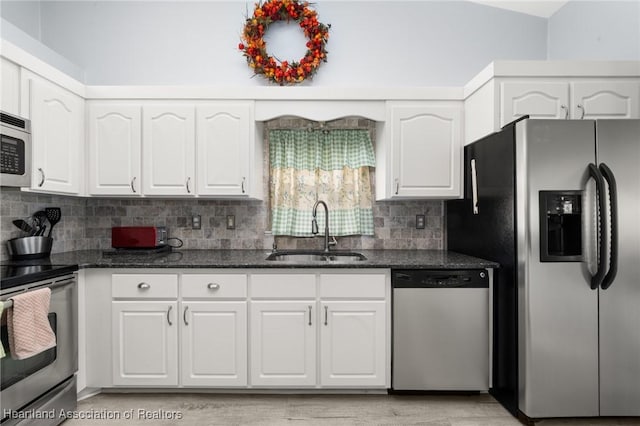 3730 Camry Ct, Sebring, FL 33872 - kitchen with appliances with stainless steel finishes, dark stone countertops, white cabinets, and decorative backsplash