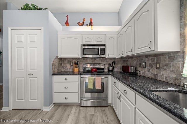 3730 Camry Ct, Sebring, FL 33872 - kitchen featuring appliances with stainless steel finishes, white cabinetry, and light wood-type flooring